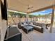 Cozy covered patio featuring a ceiling fan and comfortable wicker sectional sofa with throw pillows and a coffee table at 4446 E Woodridge Dr, Phoenix, AZ 85032