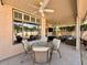 Relaxing covered patio with ceiling fans, dining table and chairs, and comfortable seating area with views of outdoors at 4446 E Woodridge Dr, Phoenix, AZ 85032