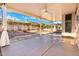 This covered patio is perfect for entertaining or relaxing outdoors with ceiling fan and open backyard at 4446 E Woodridge Dr, Phoenix, AZ 85032