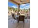 Outdoor patio featuring a dining table set, lounge chair and well-manicured landscaping views at 4446 E Woodridge Dr, Phoenix, AZ 85032