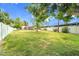 Large backyard with green grass, perimeter fencing, privacy landscaping and a pool with patio seating at 4611 E Monterosa St, Phoenix, AZ 85018