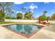 Beautiful backyard featuring a sparkling pool, seating, lush greenery, and ample patio space at 4611 E Monterosa St, Phoenix, AZ 85018