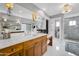Bright bathroom featuring marble counters, dual sinks, and large glass shower at 4611 E Monterosa St, Phoenix, AZ 85018