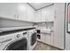 Well-equipped laundry room with modern washer, dryer, storage cabinets, and sink at 4611 E Monterosa St, Phoenix, AZ 85018