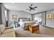 Spacious main bedroom featuring a ceiling fan, sliding glass doors, and cozy sitting area at 4611 E Monterosa St, Phoenix, AZ 85018