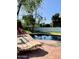 Relaxing pool area with patio, lounge chairs, greenery and clear blue pool at 4611 E Monterosa St, Phoenix, AZ 85018
