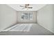 Spacious bedroom featuring a ceiling fan and a large window with blinds at 5029 N 86Th Dr, Glendale, AZ 85305