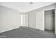A bedroom featuring gray carpet flooring, neutral walls, and closet at 5029 N 86Th Dr, Glendale, AZ 85305