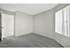 A bedroom featuring a window, light gray walls, carpet flooring, and a closet at 5029 N 86Th Dr, Glendale, AZ 85305