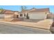 Single-story home featuring a two-car garage, desert landscaping, and a well-maintained front yard at 5029 N 86Th Dr, Glendale, AZ 85305