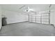 Clean, spacious garage with bright lighting, a functional garage door, and painted walls, ready for parking or projects at 5029 N 86Th Dr, Glendale, AZ 85305