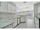 Bright kitchen features white cabinets, stainless appliances, and granite countertops, perfect for cooking at 5029 N 86Th Dr, Glendale, AZ 85305
