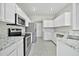 Bright kitchen features white cabinets, granite countertops, and stainless steel appliances at 5029 N 86Th Dr, Glendale, AZ 85305