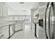 Modern kitchen featuring stainless steel appliances, granite countertops, and white cabinetry at 5029 N 86Th Dr, Glendale, AZ 85305
