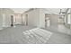 An open living room boasts neutral paint, gray carpet, and tile flooring connecting to the kitchen at 5029 N 86Th Dr, Glendale, AZ 85305