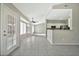 Bright open-concept living area featuring tile floors, a ceiling fan, and access to the modern kitchen at 5029 N 86Th Dr, Glendale, AZ 85305