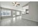 Open-concept living room with tile floors, ceiling fan, and access to kitchen and backyard at 5029 N 86Th Dr, Glendale, AZ 85305