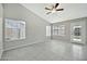Spacious living room with tile flooring, large windows, and a ceiling fan at 5029 N 86Th Dr, Glendale, AZ 85305