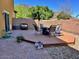 Serene backyard showcasing a wooden deck with table and chairs, offering a peaceful outdoor retreat at 5436 W Chisum Trl, Phoenix, AZ 85083