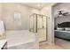 Bright bathroom featuring a bathtub, a glass-walled shower, and a view to a bedroom at 5436 W Chisum Trl, Phoenix, AZ 85083