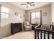 Cozy Bedroom with a crib, changing table, chair, and window for natural light at 5436 W Chisum Trl, Phoenix, AZ 85083