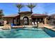 View of the community pool with a blue chair, lounge chairs, and palm trees at 5436 W Chisum Trl, Phoenix, AZ 85083