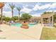 A community pool with clear blue water, lounge chairs, palm trees, and a mountain view at 5436 W Chisum Trl, Phoenix, AZ 85083