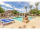 Community pool area with lounge chairs, picnic tables, and blue skies at 5436 W Chisum Trl, Phoenix, AZ 85083