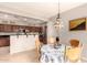 Charming dining area features a decorative chandelier, table with seating, and easy access to the kitchen at 5436 W Chisum Trl, Phoenix, AZ 85083