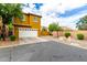 Two-story home showcasing a white garage door, desert landscaping and well-manicured yard at 5436 W Chisum Trl, Phoenix, AZ 85083