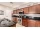Well-lit kitchen with stainless steel appliances, dark countertops, and natural wood cabinets with stylish fixtures at 5436 W Chisum Trl, Phoenix, AZ 85083