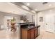 Well-lit kitchen featuring dark countertops, stainless steel appliances, and a breakfast bar with dining area at 5436 W Chisum Trl, Phoenix, AZ 85083