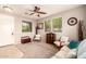 Inviting living room featuring a ceiling fan, large windows, and comfortable seating at 5436 W Chisum Trl, Phoenix, AZ 85083