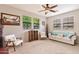 Inviting living room featuring a ceiling fan, large windows, and comfortable seating at 5436 W Chisum Trl, Phoenix, AZ 85083