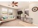 Inviting living room featuring a ceiling fan, large windows, and comfortable seating and adjacent staircase at 5436 W Chisum Trl, Phoenix, AZ 85083