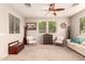 Inviting living room featuring a ceiling fan, large windows, and comfortable seating at 5436 W Chisum Trl, Phoenix, AZ 85083