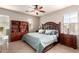 Inviting main bedroom with a ceiling fan, bedside tables, an upholstered headboard, and built-in shelving at 5436 W Chisum Trl, Phoenix, AZ 85083