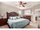 Inviting main bedroom features a ceiling fan, side tables, an upholstered headboard, and dresser at 5436 W Chisum Trl, Phoenix, AZ 85083