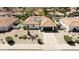 Expansive aerial view showcasing the home's tile roof, xeriscaping, and landscaping in a neighborhood setting at 5719 E Paradise Ln, Scottsdale, AZ 85254