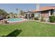Private backyard featuring a sparkling swimming pool and a covered patio, perfect for relaxation at 5719 E Paradise Ln, Scottsdale, AZ 85254