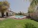 Expansive backyard with a sparkling pool, diving board, covered patio, and lush landscaping, creating an outdoor oasis at 5719 E Paradise Ln, Scottsdale, AZ 85254