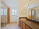 Well-lit bathroom featuring a long vanity, double sinks, a glass shower, and neutral tones, offering a clean and functional space at 5719 E Paradise Ln, Scottsdale, AZ 85254