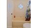 Bathroom with a tub, a shower curtain, and a stained-glass window at 5719 E Paradise Ln, Scottsdale, AZ 85254