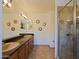 Spacious bathroom with double sinks, a large mirror, and a glass-enclosed shower, perfect for modern living at 5719 E Paradise Ln, Scottsdale, AZ 85254