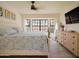 Serene bedroom with a calming ambiance, complemented by a large window, ceiling fan, and elegant furnishings at 5719 E Paradise Ln, Scottsdale, AZ 85254