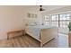 Bright bedroom featuring a large window, stylish bed, and wood-look floors, creating a comfortable retreat at 5719 E Paradise Ln, Scottsdale, AZ 85254