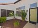 Inviting entrance with desert-friendly plants and a stylish front door, providing curb appeal at 5719 E Paradise Ln, Scottsdale, AZ 85254