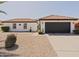 Charming single-story home with a well-maintained front yard, desert landscaping and a black garage door at 5719 E Paradise Ln, Scottsdale, AZ 85254