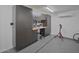 Garage with epoxy flooring and a work bench with storage cabinets at 5719 E Paradise Ln, Scottsdale, AZ 85254