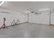 Spacious garage with epoxy flooring and an automatic garage door at 5719 E Paradise Ln, Scottsdale, AZ 85254